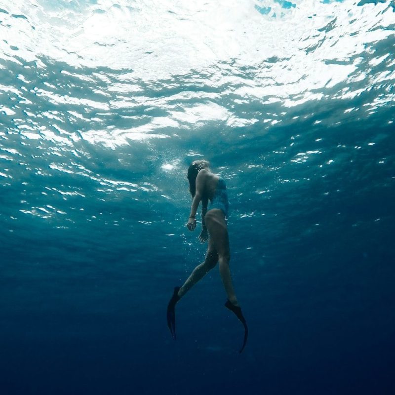 a man riding a wave on top of a body of water